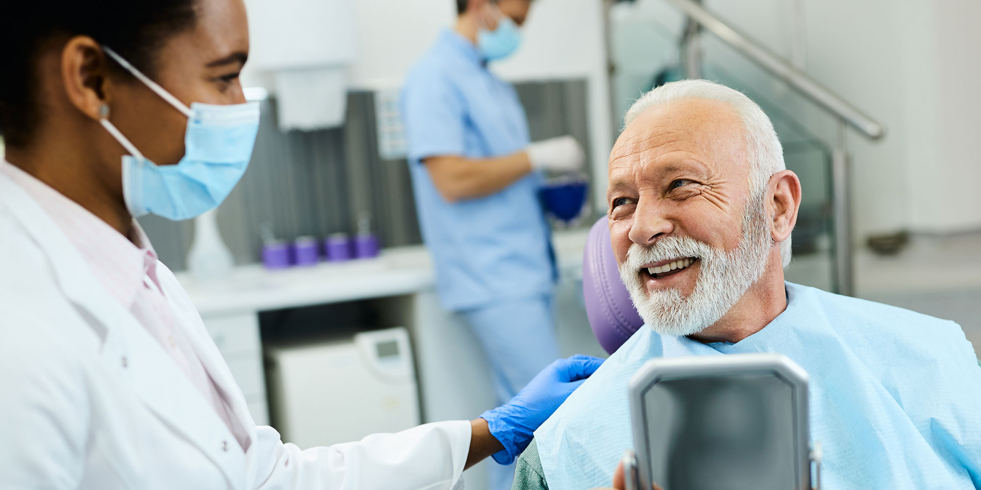 patient with mirror happy with implant results